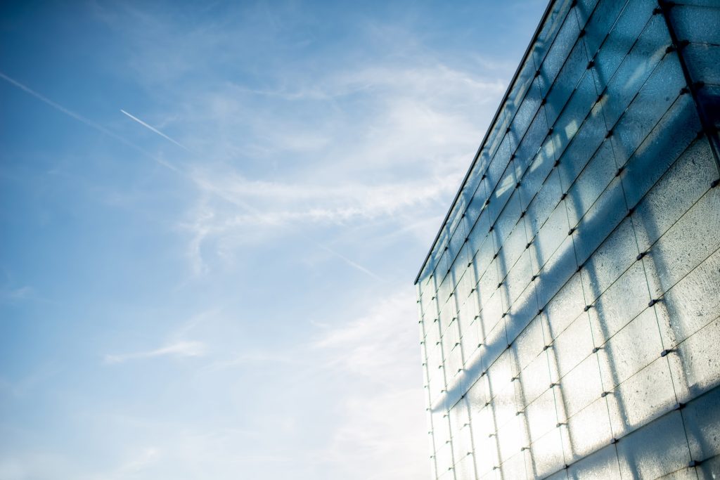 Modern glass facade on the blue sky background